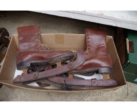 A pair of vintage brown leather ice skates; together with two further pairs of skate blades. 