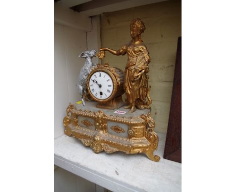 A Louis XVI style gilded spelter and alabaster mantel clock.
