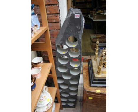 An unusual slate wine rack, with 22 bottle apertures, 123cm high. 