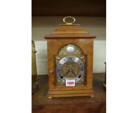 A reproduction walnut mantel type clock, by Elliott, with bell striking movement, 29cm high. 