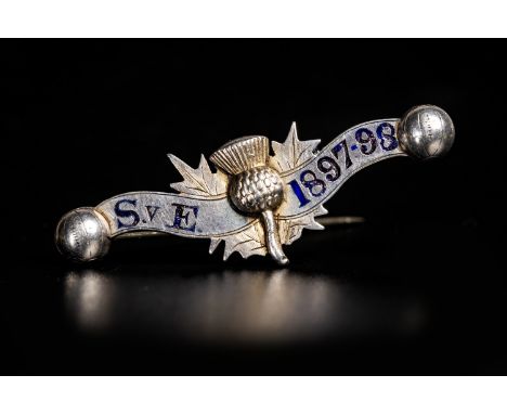 1898 SCOTLAND V ENGLAND SILVER BADGE, the obverse with central thistle motif, with 'S v E' and '1897-98' in blue enamel, the 