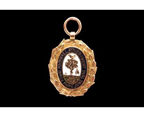 1910 IBROX PARK FOOTBALL TOURNAMENT GOLD MEDAL, the obverse with central enamelled oval plaque depicting bird and tree motif,