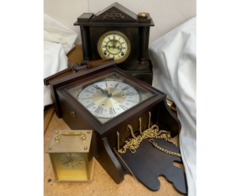 A black slate mantle clock together with a wall clock and a brass carriage clock