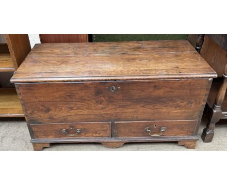 An 18th century coffer, with a planked top and two drawers on bracket feet, 94cm wide x 47cm deep x 48cm high 