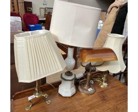 A brass table lamp with three legs together with another brass table lamp, opaque glass table lamp and a desk lamp
