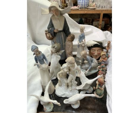 A large Lladro figure of a nun and a child together with a Lladro figure of a girl feeding ducks, three Lladro geese, three H