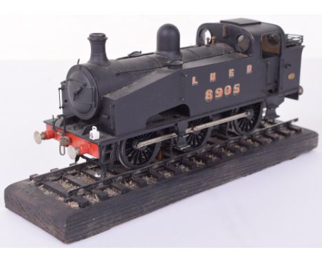 0 gauge brass and metal 0-6-0 LNER tank engine No.8905, 2-rail electric finished in black, mounted on a wooden track plinth, 