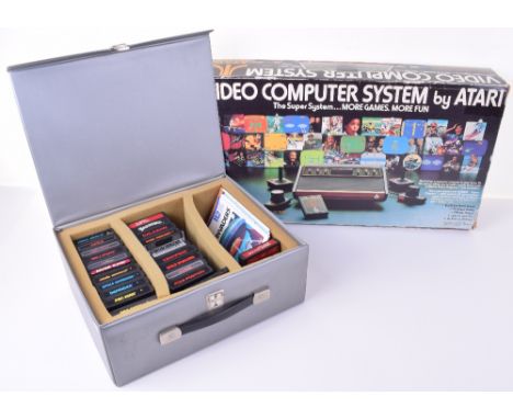 Boxed Atari Model No. CX-2600 Video Computer Games System, with two sets of remote controllers, Atari games case with 23 game