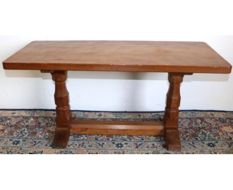Robert Mouseman Thompson of Kilburn - an oak rectangular coffee table, adzed top on octagonal baluster end supports joined by