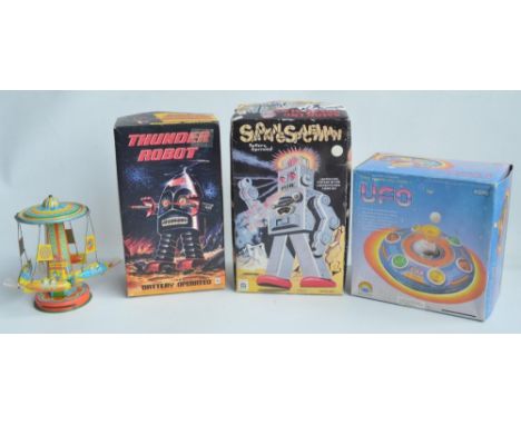 Two boxed battery operated 11.5" metal robot figures from Ha Ha Toys to include Smoking Spaceman (very good condition with so