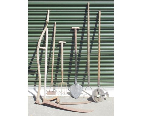 Selection of vintage gardening tools of various styles and uses, including a scythe, hoe, edging tools, a hay fork etc. 