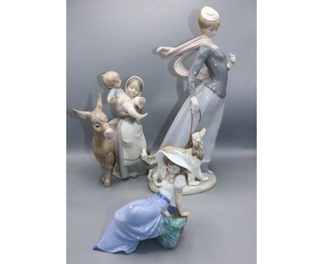 Lladro figure 4914 Lady with Shawl, H43cm, lacking parasol; Nao figure of a girl with a bird, seated on a rock, H15cm; and a 