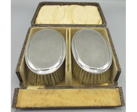 Pair of silver George V brushes with engine turned pattern, in a fitted case by A &amp; J Zimmerman, Birmingham, 1919, 9.3ozt