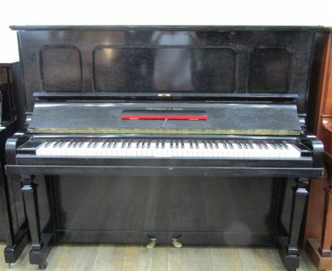 Steinway (c1925)A Model K upright piano in an ebonised case.