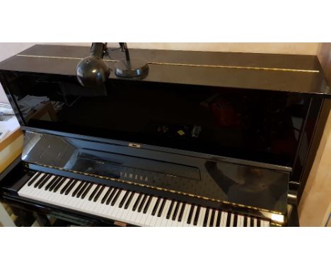Yamaha (c1997)A Model U3 upright piano in a bright ebonised case; together with a matching adjustable stool.