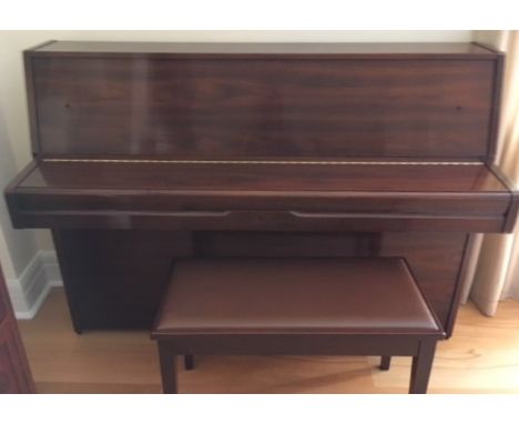 Yamaha (c1985) A Model M1J upright piano in a satin walnut case; together with a stool.  AMENDMENT Is in a bright walnut case