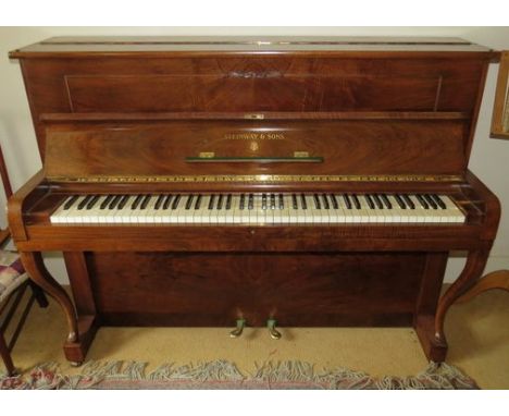 Steinway (c1939) A Model Z upright piano in a walnut case with cabriole front supports; together with a piano chair with cabr