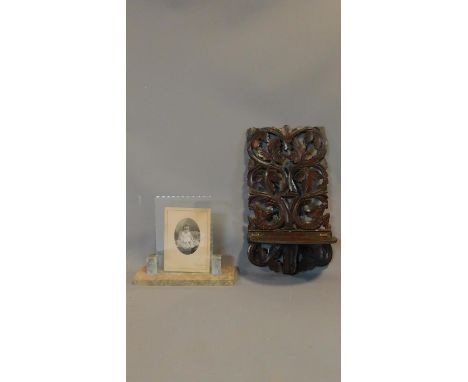 A 19th century Black Forest carved hanging shelf and an Art Deco marble photograph frame. 48x26cm 