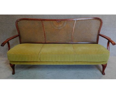 A mid 20th century bergere caned sofa, makers label to base. H.86 W.170 D.60cm 