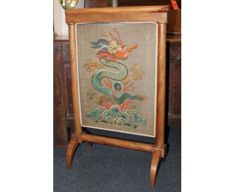 A 19th century mahogany fire screen with brass mounts and tapestry screen decorated with a dragon, 57cm