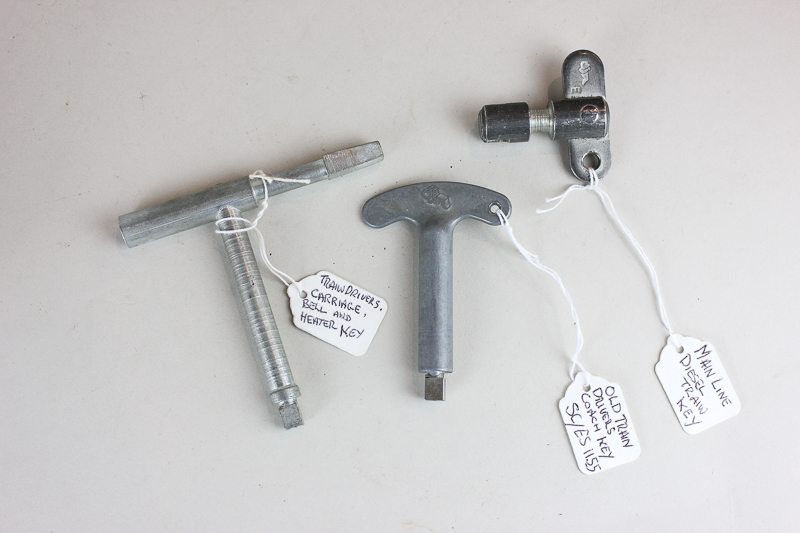 A Mainline diesel train key, a train conductor's carriage, bell and