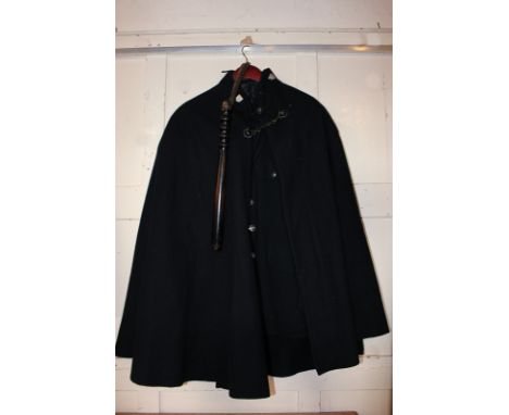 An early 20th century policeman's uniform with jacket, cloak and truncheon
