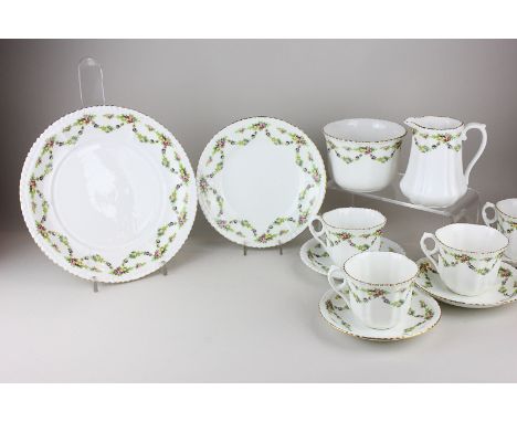 A Phoenix china part tea set with floral swag decoration and gilt edging, including two sandwich plates, eleven tea plates, t