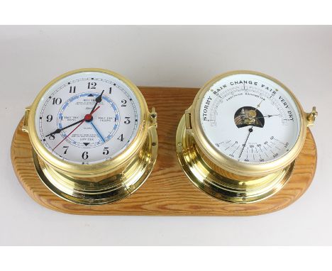 A brass bulkhead barometer and clock set by Hermle, on pine wall mount, 45cm