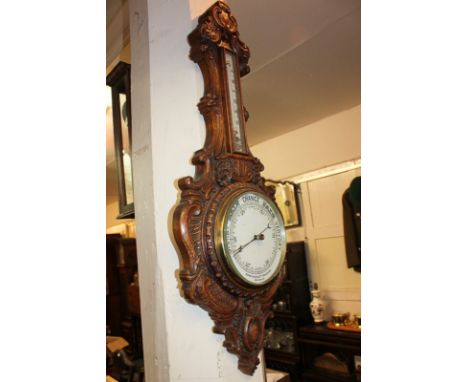 A 19th century carved oak wheel barometer by Benetfink & Co, Cheapside, London, with thermometer