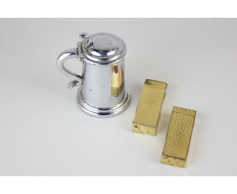 Two gold plated Dunhill lighters and a white metal Dunhill table lighter in the shape of a tankard