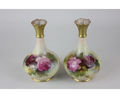 A pair of Royal Worcester bottle neck vases, hand painted with roses and gilt embellishment, 14cm