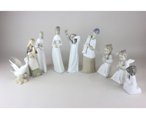 Two Lladro porcelain figures of cherubs playing pipes, together with seven similar Spanish porcelain figures