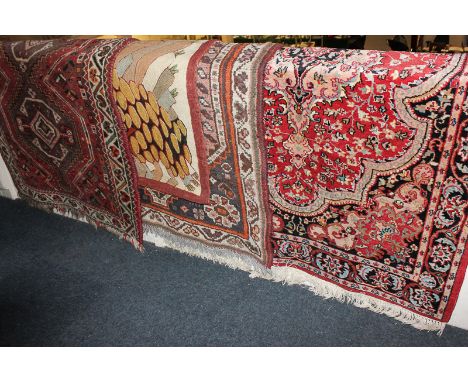 Three various wool rugs together with a wool tapestry depicting a landscape