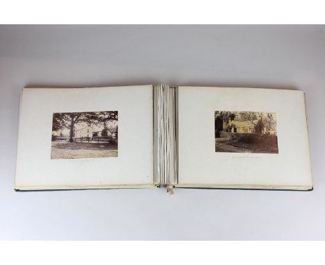 A Victorian scrapbook containing a watercolour, a drawing, an etching and mostly topographical photographs