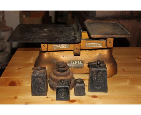 A set of scales marked W & T Avery Ltd, Birmingham, with nine weights