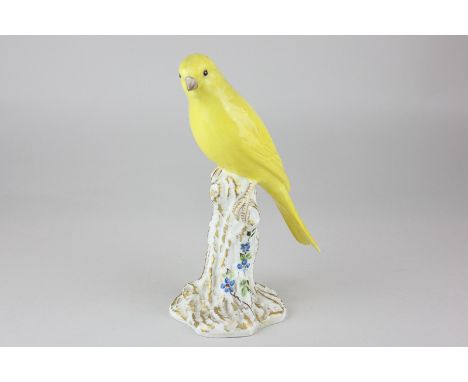 A Royal Worcester porcelain figure of a canary perched on a gilt and floral tree stump, 17cm