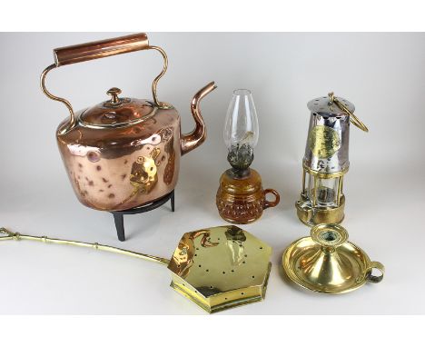 A copper kettle, a cast iron trivet, a miner's lamp, a chamber stick, an oil lamp, a chestnut pan and a warming pan