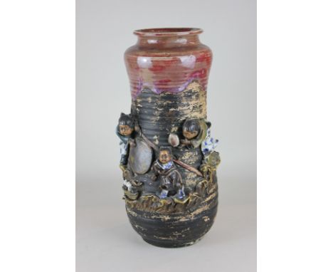 A 19th century Japanese pottery vase (circa 1880) with overlaid decoration of children playing with red slip glaze to rim, si