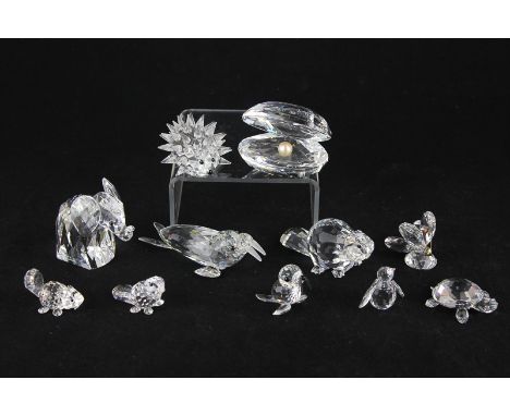 Eleven Swarovski crystal figures including part of the under the sea range of clam shell with pearl, walrus, seal pup and pen