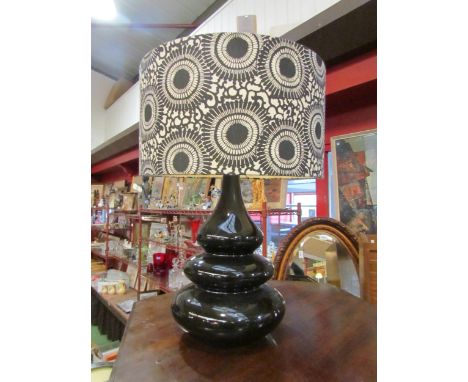 A modernist black monsoon lamp with black and white shade 