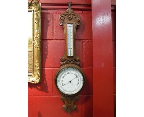 An AWG &amp; Mage Ltd., London, carved oak barometer with mercury thermometer 
