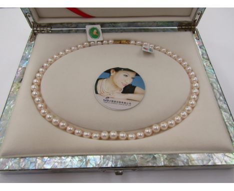 A single strand of pearls, 43cm long, in mother-of-pearl fitted box 