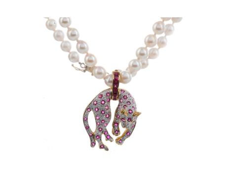 RUBY AND DIAMOND PANTHER PENDANT, the panther set with round rubies and diamonds, suspended from a ruby bale, marked 750, wit