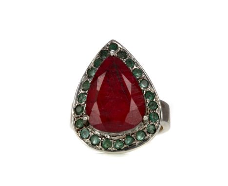 RUBY AND EMERALD RING, set with a pear shaped ruby of approximately 10.50 carats, within an emerald halo, unmarked, likely si