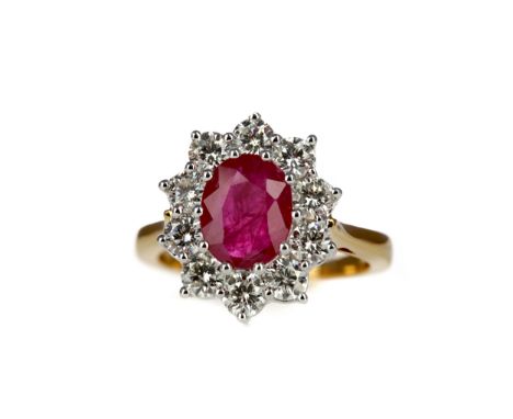 RUBY AND DIAMOND RING, set with an oval ruby of approximately 2.25 carats within a halo of round brilliant cut diamonds total