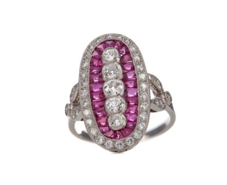 RUBY AND DIAMOND RING, set with a row of old cut diamonds within a halo of calibre cut rubies, in turn bordered by round bril