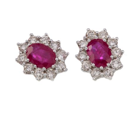 PAIR OF RUBY AND DIAMOND EARRINGS, set with oval rubies within diamond halos, the round brilliant cut diamonds totalling appr