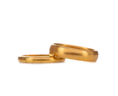 TWO GOLD WEDDING BANDS, each in twenty two carat gold, size K, 7.5g gross (2)