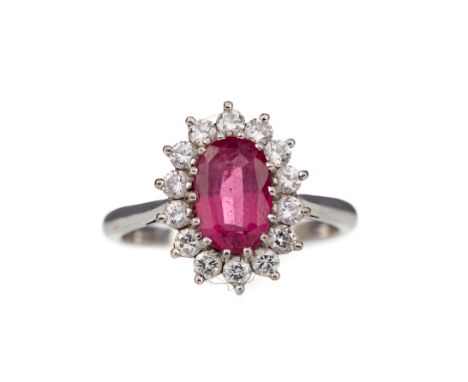 RUBY AND DIAMOND CLUSTER RING, the oval ruby within a halo of round brilliant cut diamonds totalling approximately 0.56 carat