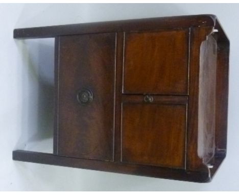 A GEORGE III (WITH LATER ALTERATIONS) MAHOGANY TRAY TOP COMMODE, having flank fretted handles, drop front, over two doors and